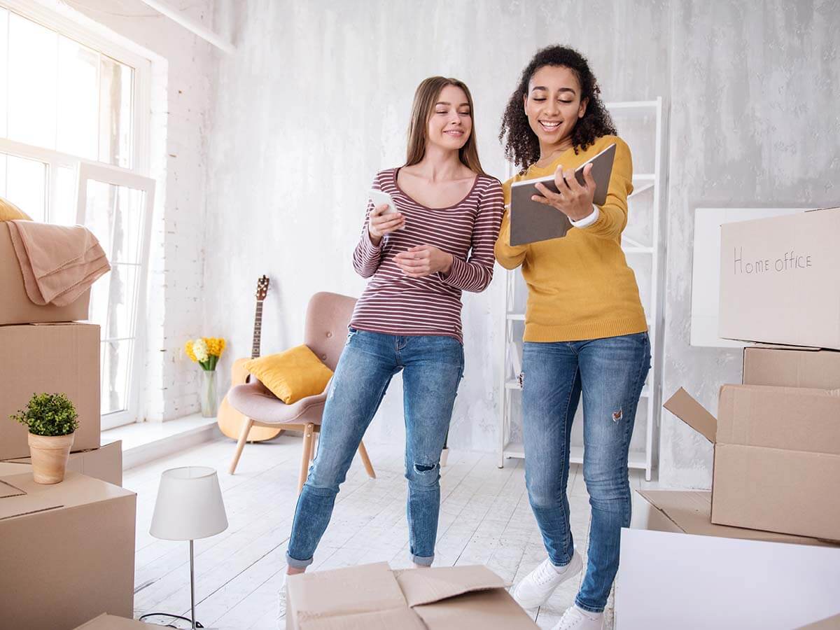 Two young women moving into rental property